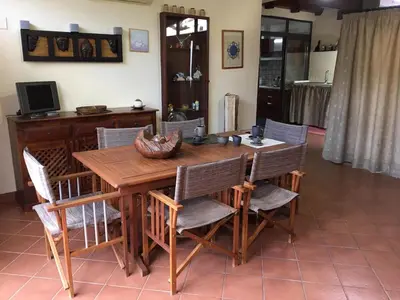 a wooden dining room table with chairs around it at Armida House - Mondello in Mondello