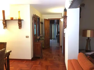 a hallway leading into a living room with wood floors at Armida House - Mondello in Mondello
