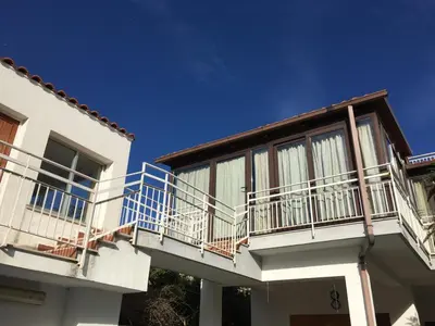 a white house with balconies on the side of it at Armida House - Mondello in Mondello