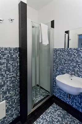 a bathroom with a sink and a glass shower at Mille e Una Notte in Nuova Gibellina