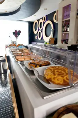 a buffet line with plates of food on display at Mille e Una Notte in Nuova Gibellina