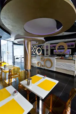 a restaurant with tables and chairs and a ceiling at Mille e Una Notte in Nuova Gibellina