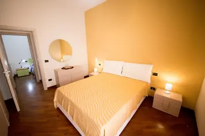 a bedroom with a bed and a mirror on the wall at Sicilia Case Vacanze in Balestrate