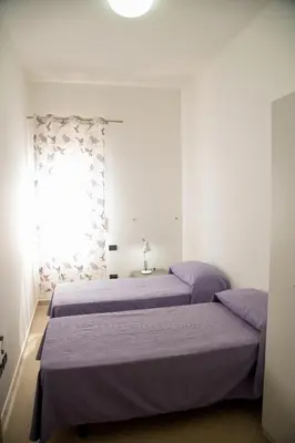 a bedroom with two beds and a window at Sicilia Case Vacanze in Balestrate