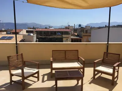 three chairs and a table on a balcony with a view at Sicilia Case Vacanze in Balestrate