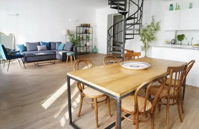 a dining room and living room with a table and chairs at T-home / Stylish apartment Palermo center in Palermo