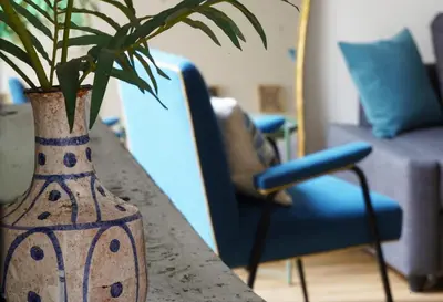 a vase sitting on a table with a plant in it at T-home / Stylish apartment Palermo center in Palermo