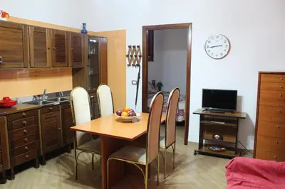 a kitchen with a table and chairs with a bowl of fruit on it at Da Angelo in Castellammare del Golfo