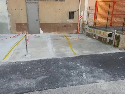 a street with yellow and red rope around a building at Apartments Bed Abate in Villabate