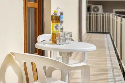 a white table with glasses and a bottle on it at Apartments Bed Abate in Villabate