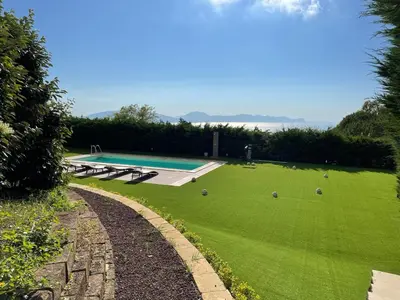 a large green yard with a swimming pool at Ziba Villa Siciliana con piscina e vista panoramica sul mare in Borgetto