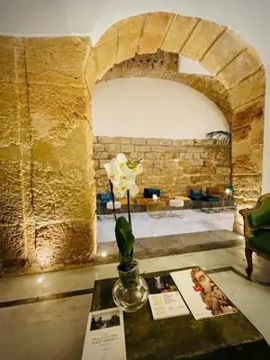 a room with a table with a vase with flowers on it at Palazzo del Poeta - Dimora Contemporanea in Palermo