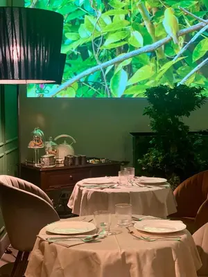 a table with white tablecloths and plates on it at Palazzo del Poeta - Dimora Contemporanea in Palermo