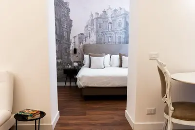 a bedroom with a bed with a drawing on the wall at Palazzo del Poeta - Dimora Contemporanea in Palermo