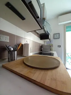 a kitchen with a wooden cutting board on a kitchen counter at Casa sul mare in Isola delle Femmine