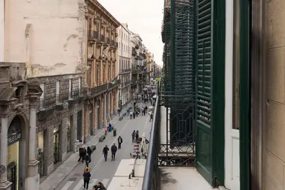 a group of people walking down a city street at Palazzo Arone dei Baroni di Valentino in Palermo