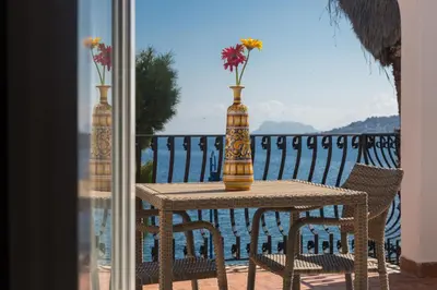 a table with two vases on top of a balcony at Villa Mallandrino in Mondello
