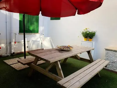 a picnic table with a bowl of food and an umbrella at Villa Mallandrino in Mondello