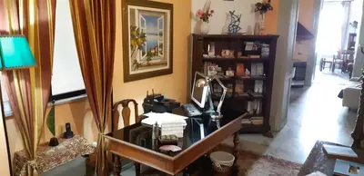 a room with a desk with a lamp and a chair at Cavour Il Conte Camillo in Palermo