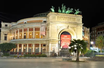 a large building with a statue in front of it at Cavour Il Conte Camillo in Palermo