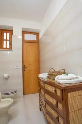 a bathroom with a sink and a toilet in a room at Casa BabbaLuciana in Mondello