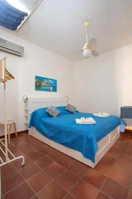 a bedroom with a bed with a blue blanket at Casa BabbaLuciana in Mondello