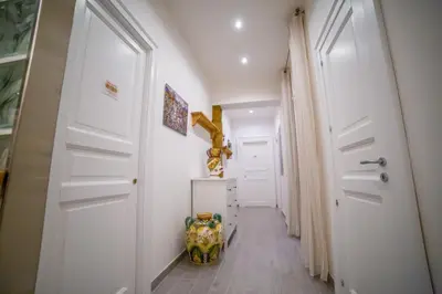 a hallway with a white door and a staircase at B&B Opera dei Pupi in Palermo