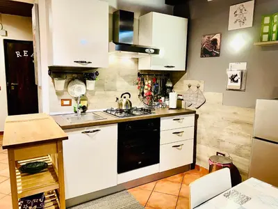 a kitchen with white cabinets and a stove top oven at Palazzo Rea in Palermo