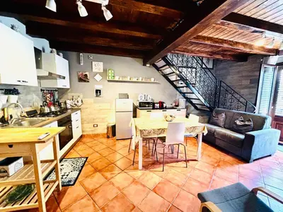 a kitchen and living room with a table and a couch at Palazzo Rea in Palermo