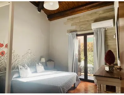 a bedroom with a large bed and a window at Palazzo Rea in Palermo