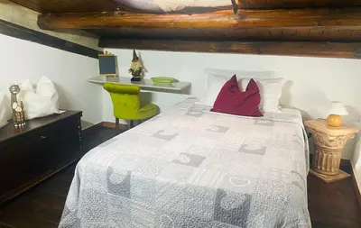 a bedroom with a bed with red pillows on it at Palazzo Rea in Palermo