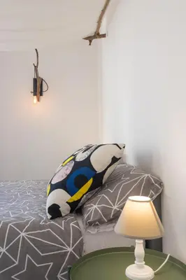 a bedroom with a bed and a table with a lamp at Central Apartment with terrace near teatro Massimo in Palermo