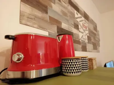 a red toaster sitting on top of a counter at Central Apartment with terrace near teatro Massimo in Palermo