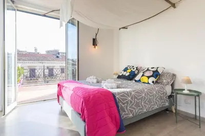 a bedroom with a bed and a large window at Central Apartment with terrace near teatro Massimo in Palermo