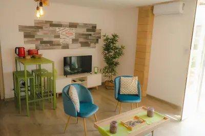 a living room with two chairs and a tv at Central Apartment with terrace near teatro Massimo in Palermo