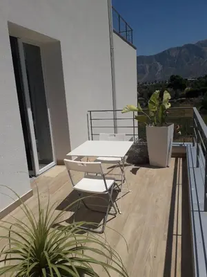 a patio with a table and chairs on a balcony at Zabbàra B&B in Terrasini
