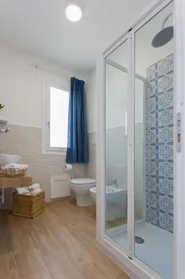 a bathroom with a toilet and a glass shower at Zabbàra B&B in Terrasini