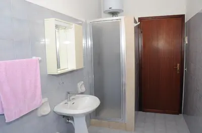 a bathroom with a toilet and a sink and a shower at case vacanze Rosy in San Vito lo Capo