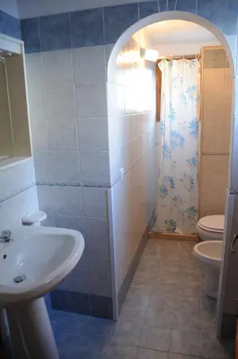 a bathroom with a sink and a toilet and a shower at case vacanze Rosy in San Vito lo Capo