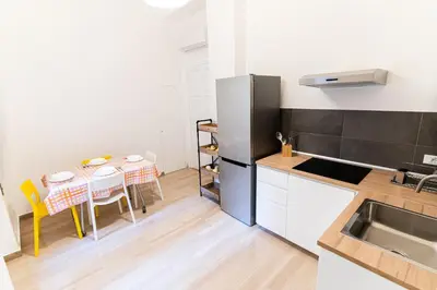 a kitchen with a table and a dining room at Central Coa Apartment in Palermo