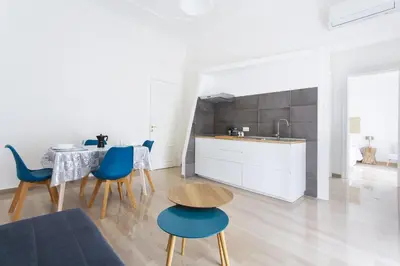 a kitchen and dining room with a table and chairs at Central Coa Apartment in Palermo