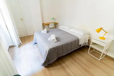 a bedroom with a bed with two towels on it at Central Coa Apartment in Palermo