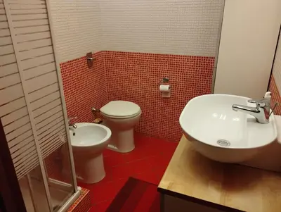 a bathroom with a toilet and a sink at Smart Apartment by the Sea near Palermo, Sicily in Isola delle Femmine