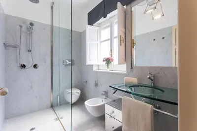 a bathroom with a glass sink and a shower at Villa Gabriella - Mondello in Mondello