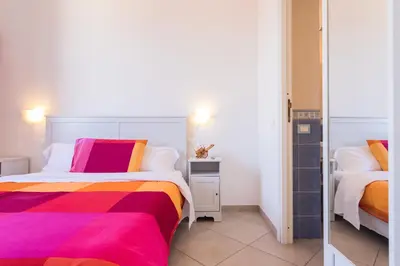 a bedroom with two beds with colorful sheets at Casa da Silvia in Palermo