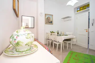 a room with a table with a vase on a counter at Casa da Silvia in Palermo