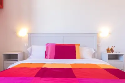 a bed with a colorful blanket on top of it at Casa da Silvia in Palermo