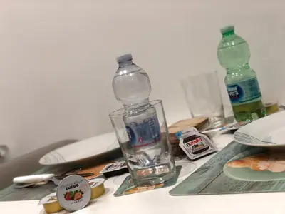 a bottle of water sitting on top of a table at STABILE139 in Palermo