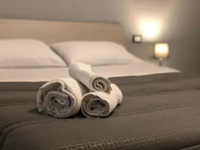 a bed with two rolled towels on it at STABILE139 in Palermo