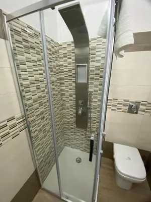 a bathroom with a glass shower with a toilet at IN CENTRO ROOMS Vicino Cefalù SELF-CHEK-IN in Campofelice di Roccella